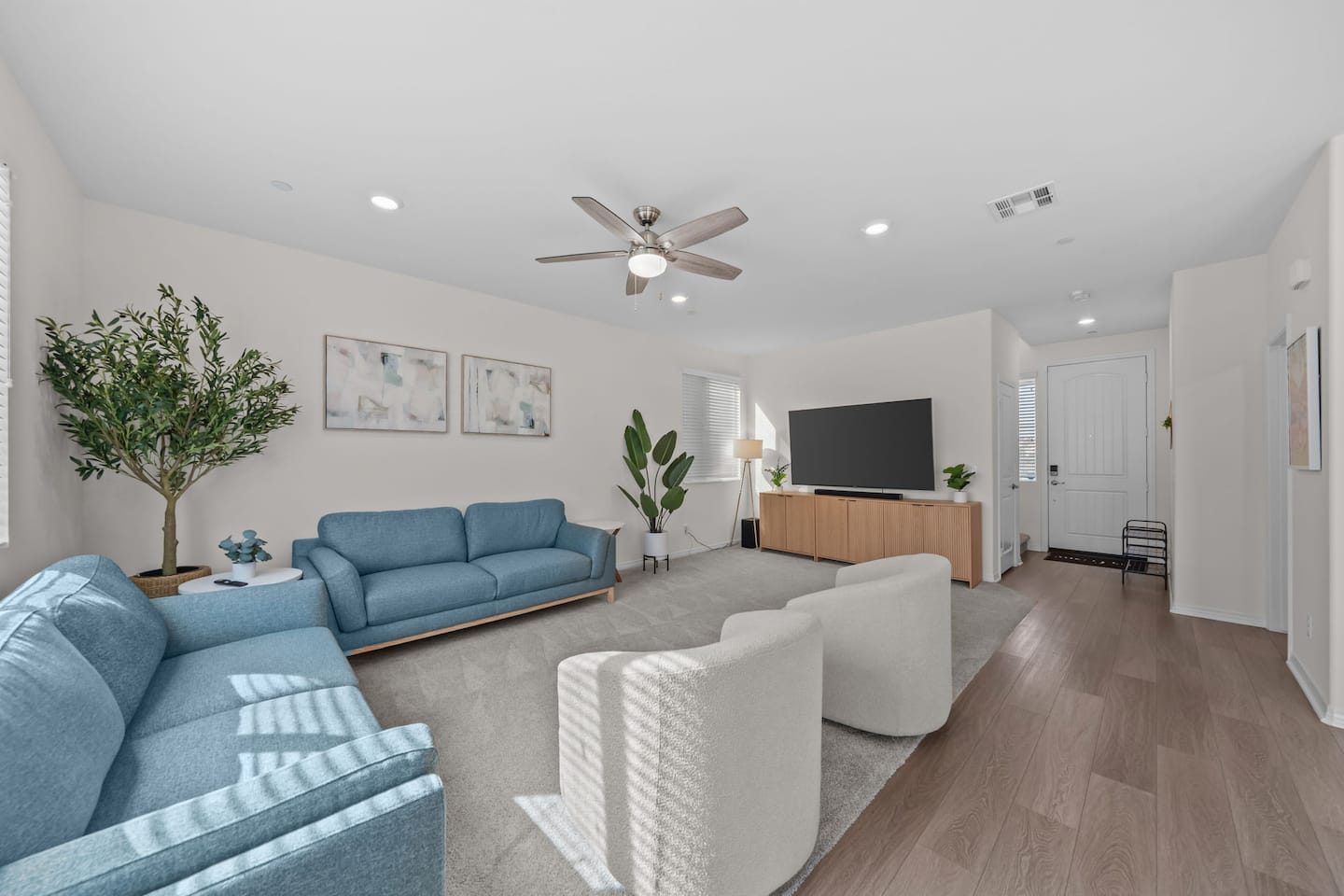 Open living room with blue sofas, Winchester home